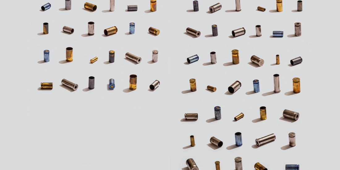 63 multicolored bullet shell casings representing the average number of gun suicides in a day