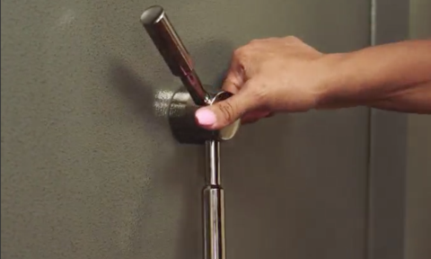 A woman's hand about to open a gun safe